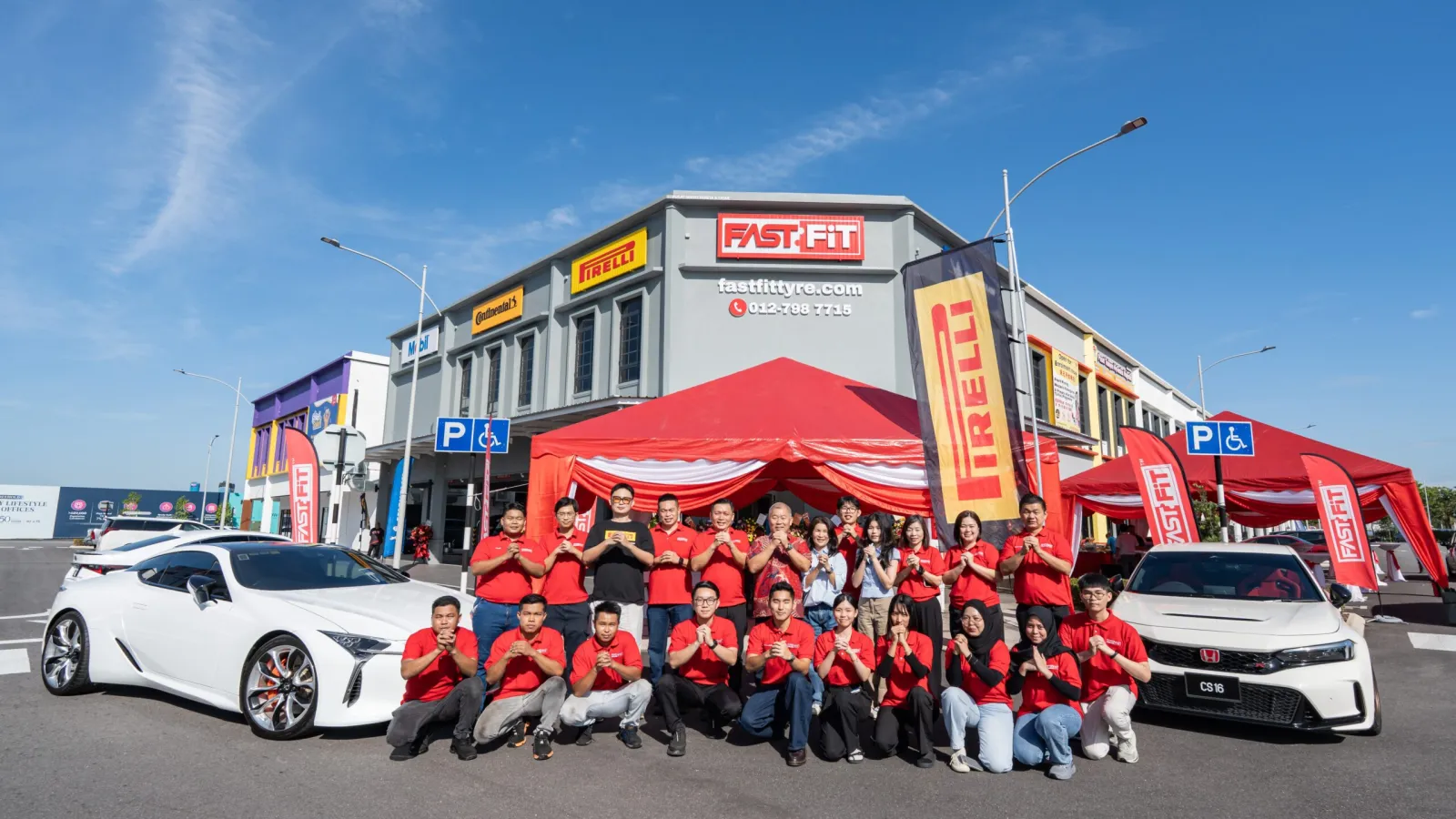 Fastfit Tyre Eco Majestic Semenyih outlet exterior with staff and display vehicles at the opening event