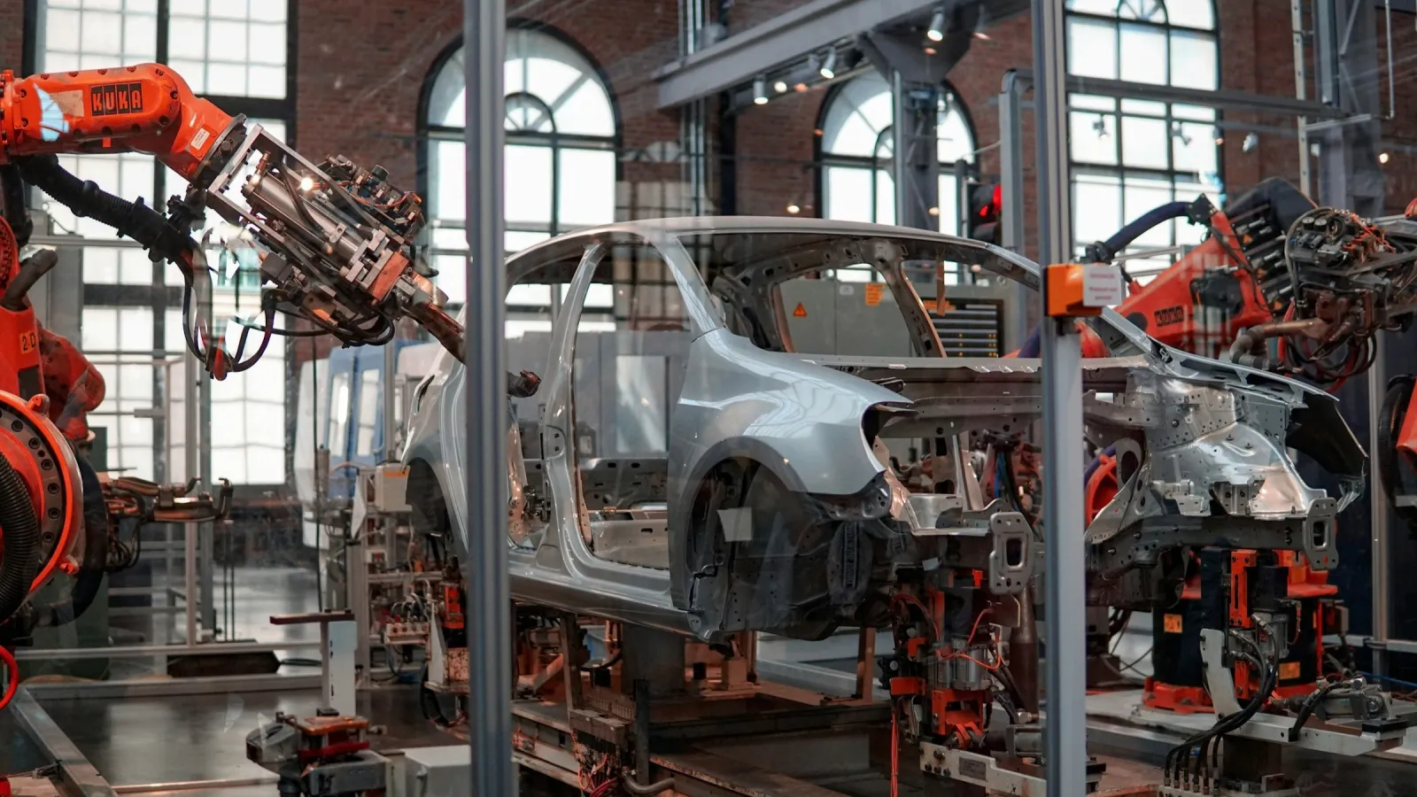 A car being manufactured in a factory (illustration). Photo Credit: Lenny Kuhne via Unsplash
